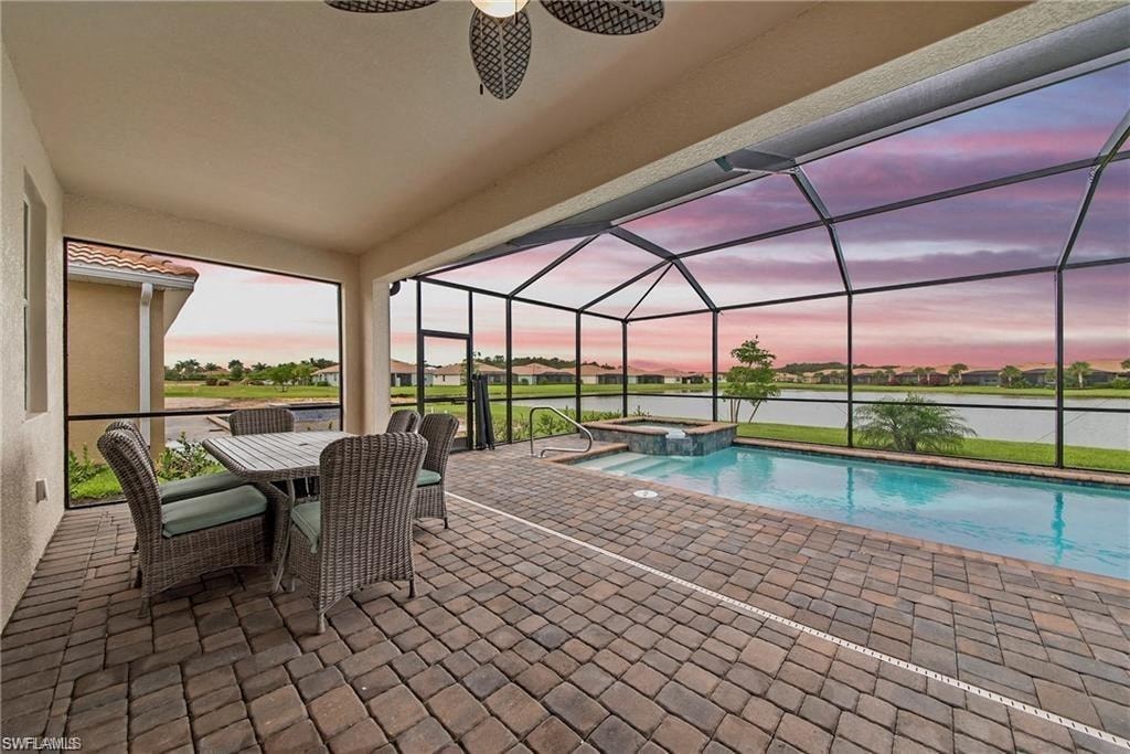 a patio with a pool and a table and chairs
