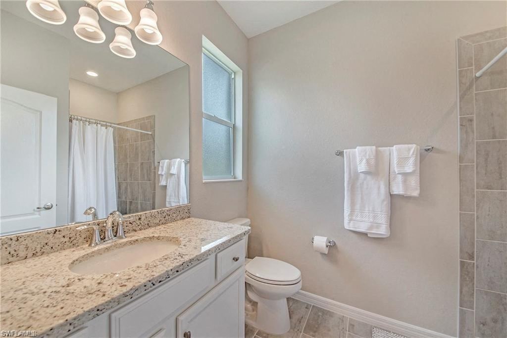 a bathroom with a toilet and a sink and a mirror