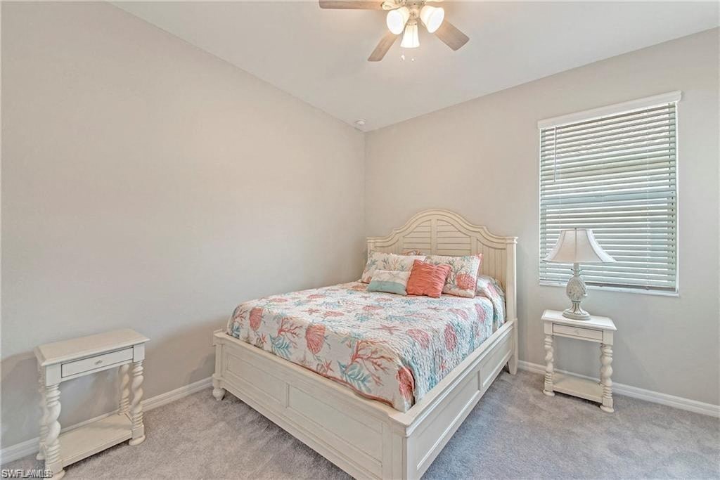 a bedroom with a bed and a ceiling fan