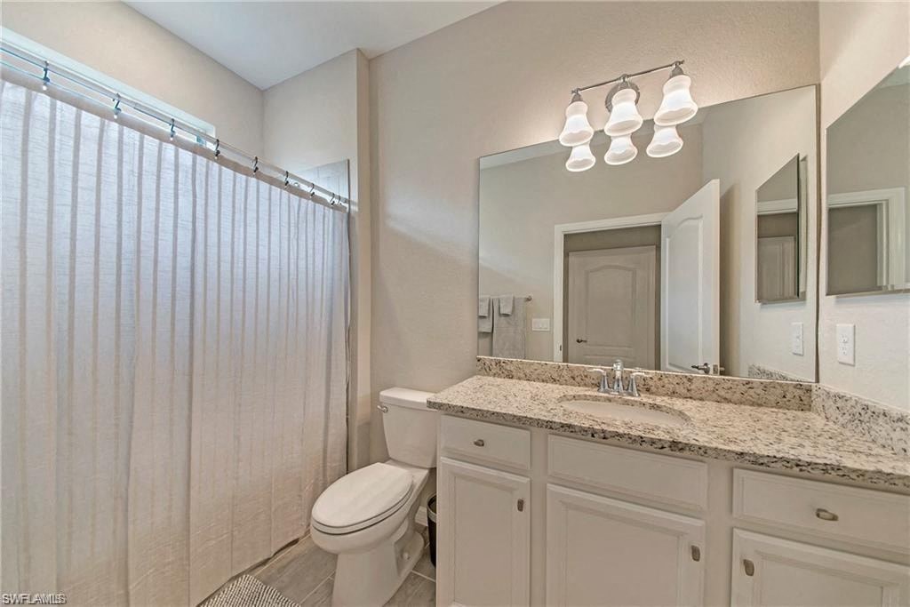 a bathroom with a shower toilet and a sink