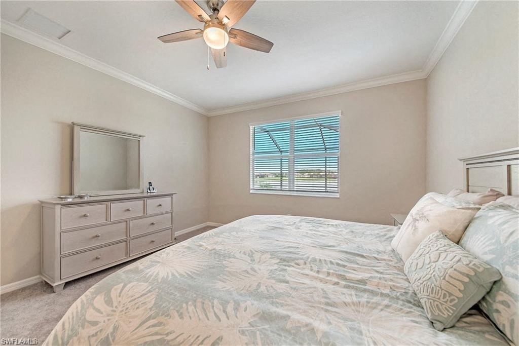 a bedroom with a large bed and a ceiling fan