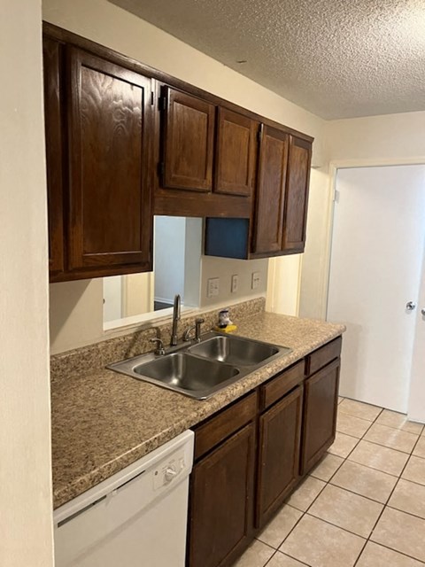 a kitchen with a sink and wooden cabinets