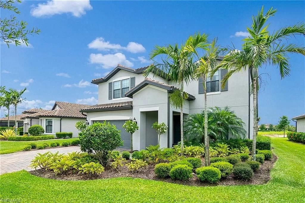 a house with palm trees in front of it
