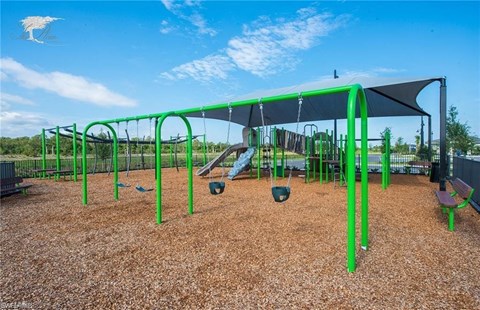 a playground with a swing set and other playground equipment