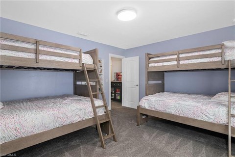 a bunk bed room with two bunk beds and a closet