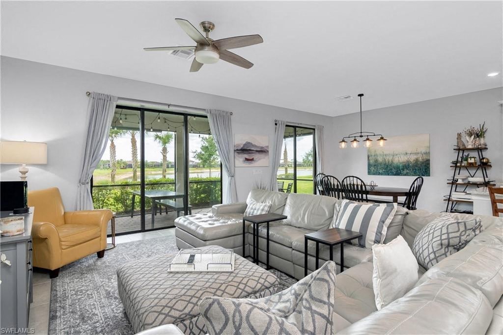 a living room with a couch and a ceiling fan