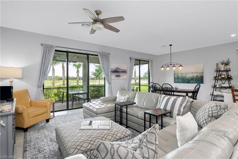 a living room with a couch and a ceiling fan