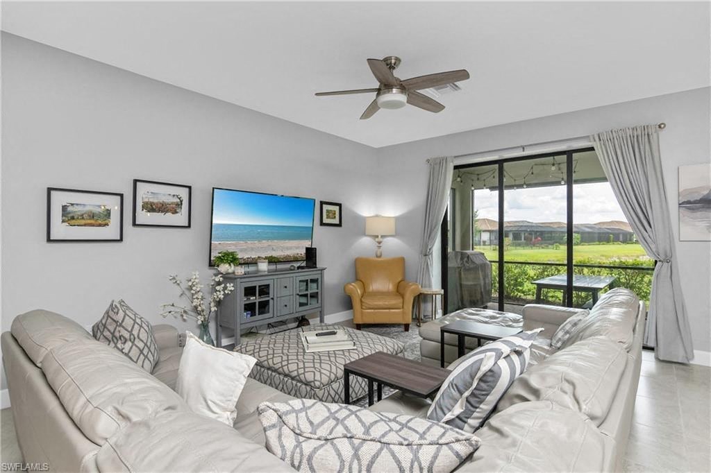 a living room with a couch and a ceiling fan