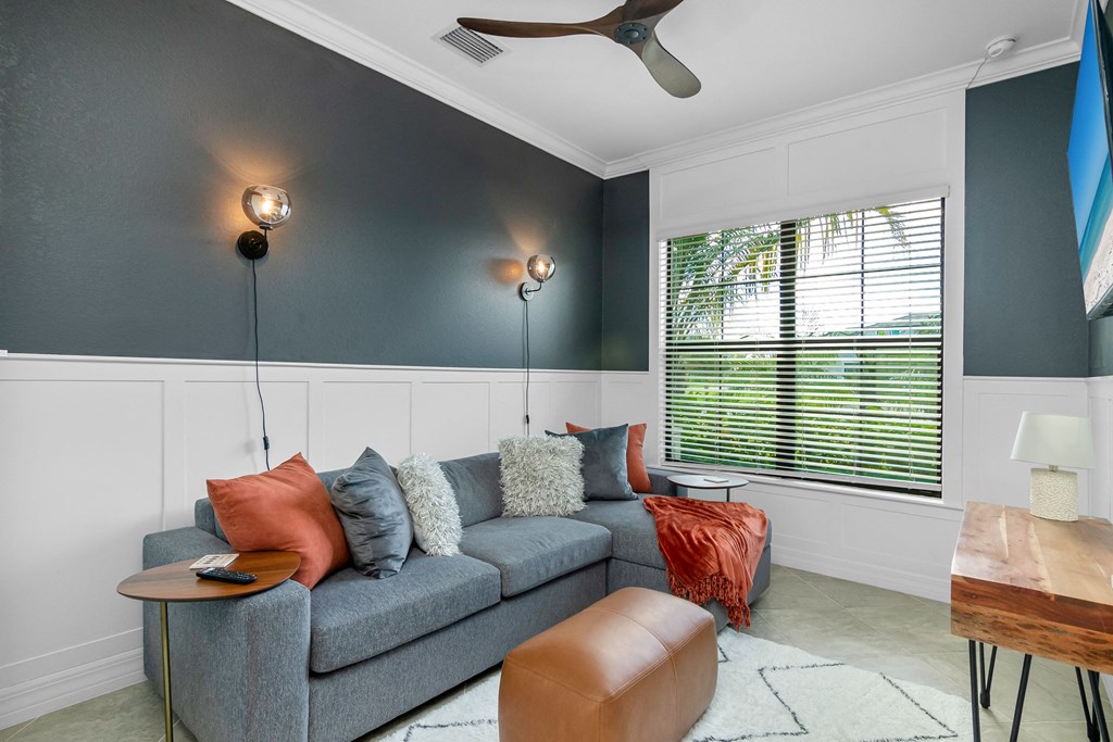 a living room with a couch and a table and a window