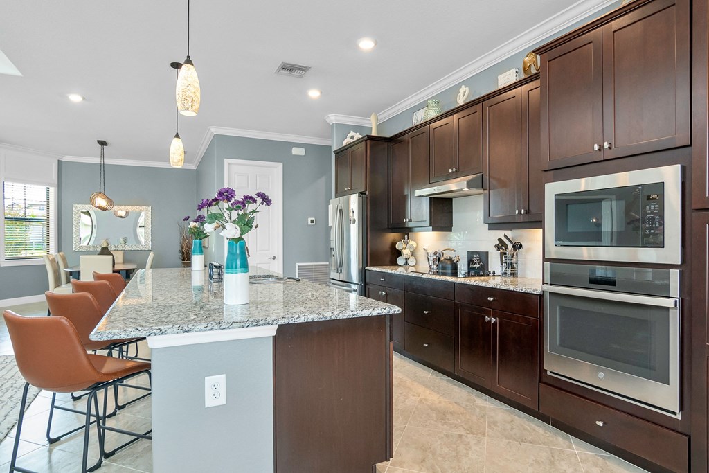 a kitchen with stainless steel appliances and a marble counter top