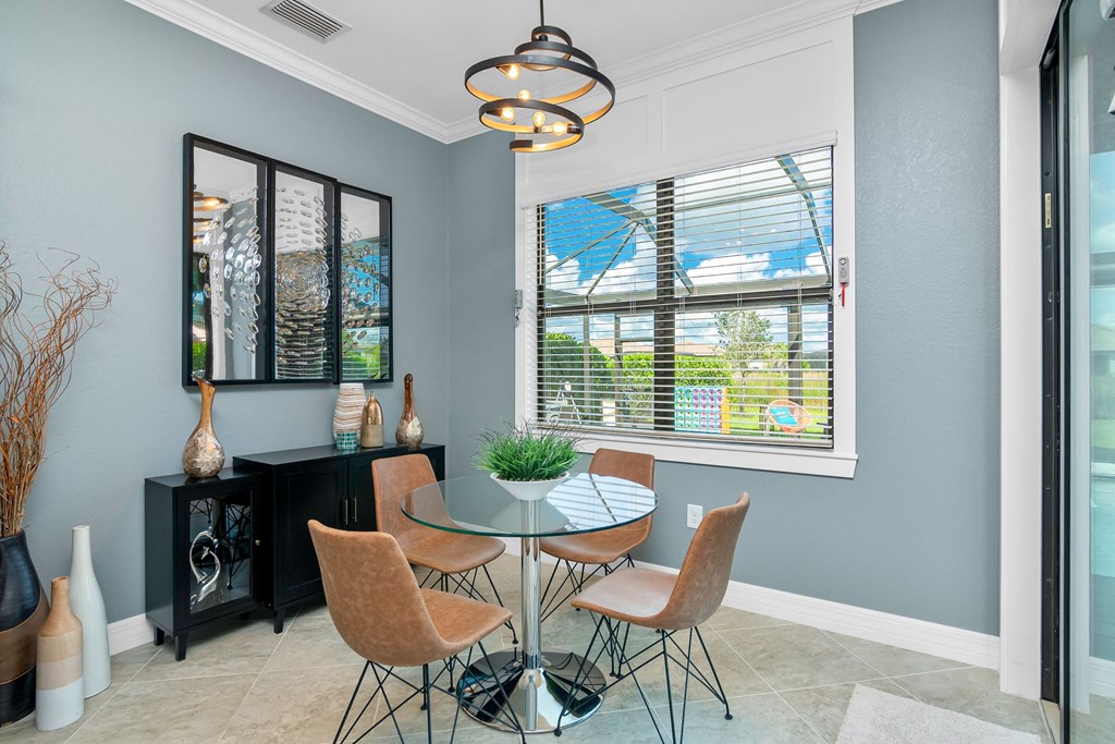 a dining room with a table and chairs and a window