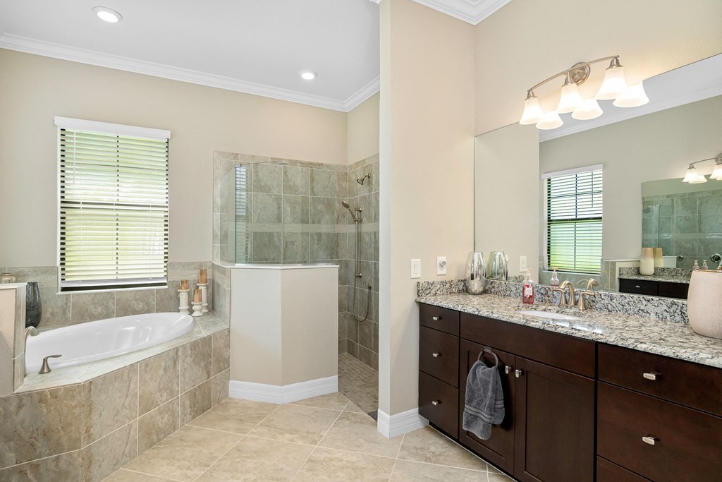 a large bathroom with a tub and a shower and a sink