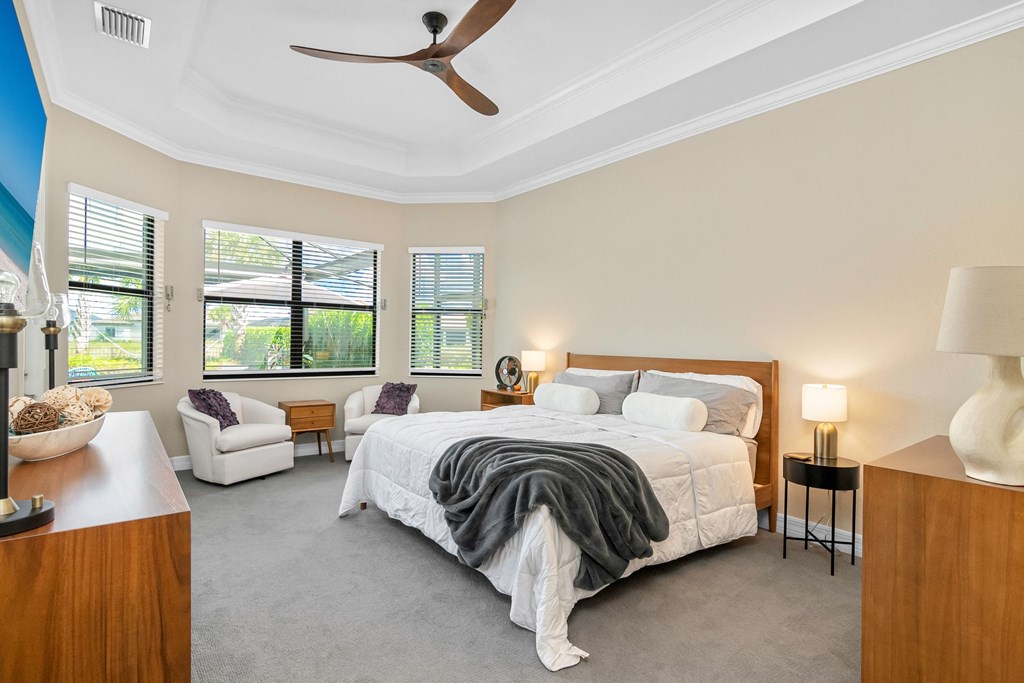 a bedroom with a bed and a ceiling fan