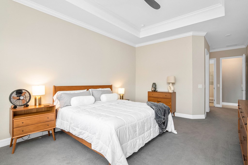 a bedroom with a bed and two dressers