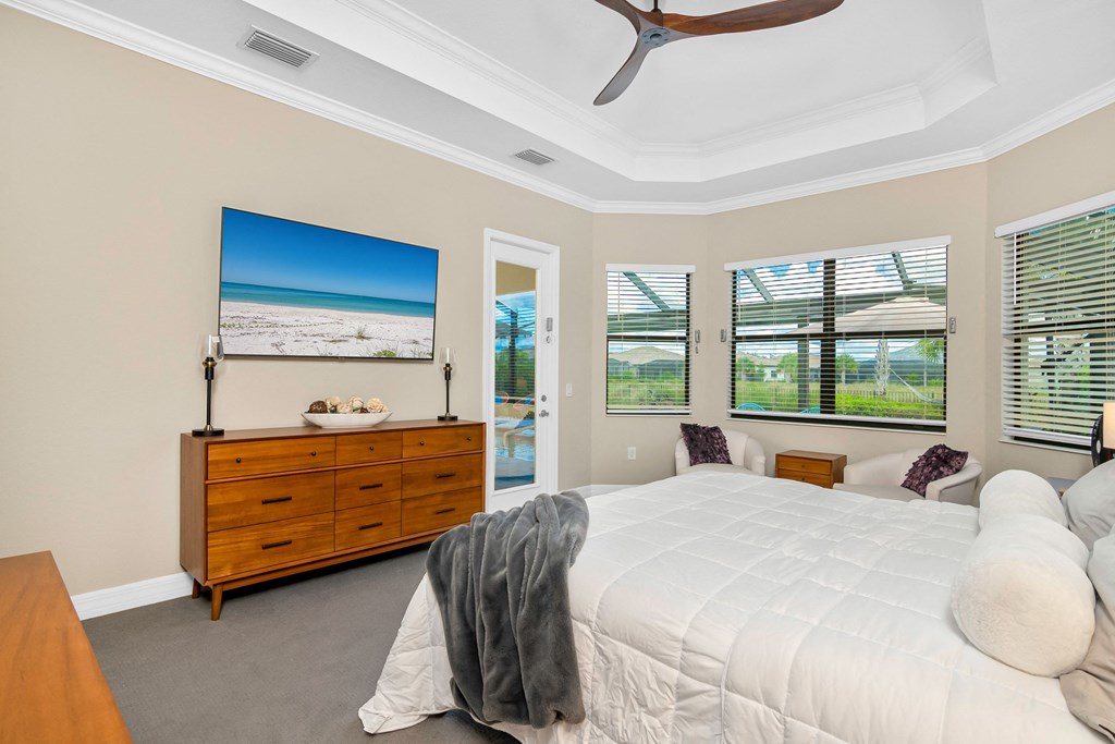 a bedroom with a large bed and a dresser and windows