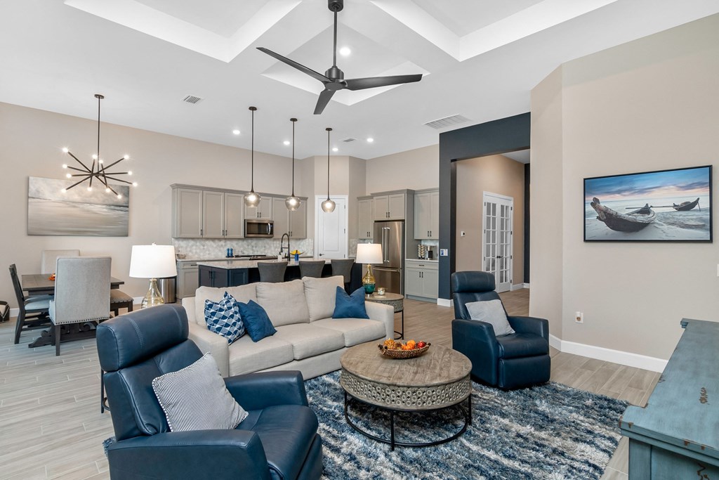 a living room with couches and chairs and a table