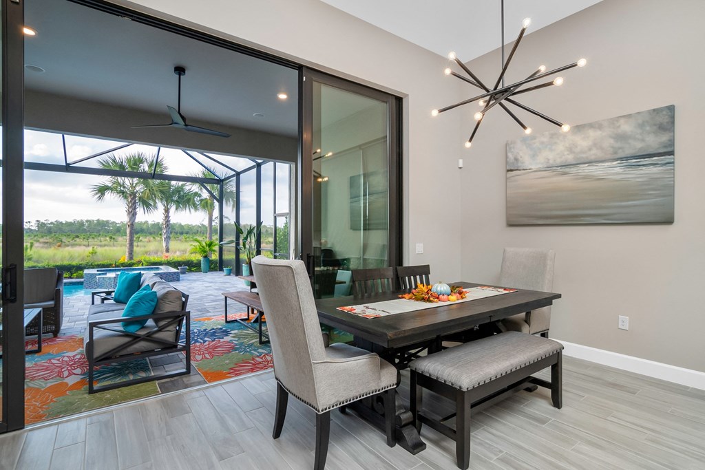 a dining room with a table and chairs and a large glass window