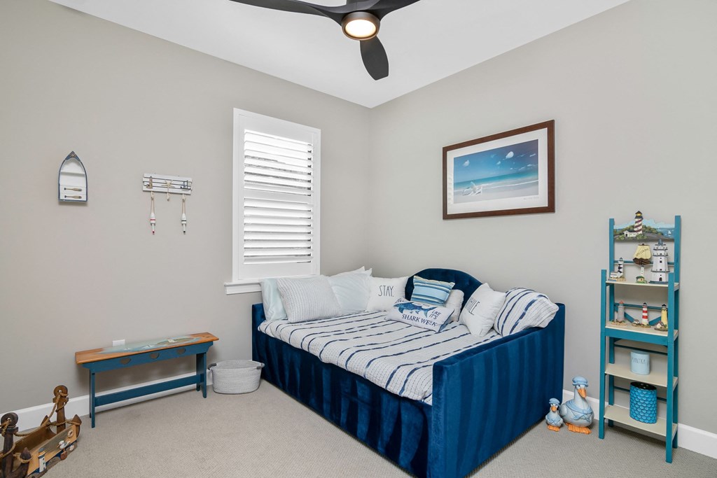 a bedroom with a bed and a ceiling fan