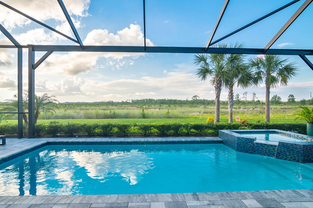 a large swimming pool with palm trees in the background