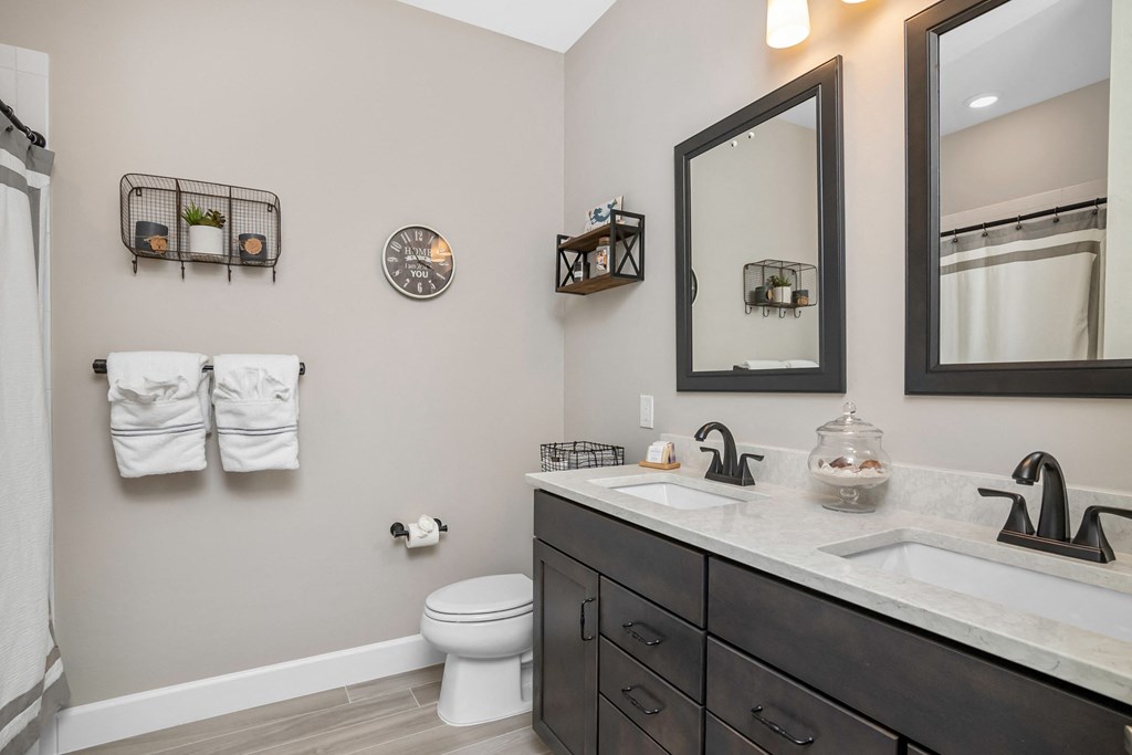 the retreat guest bathroom with twin sinks and a large mirror