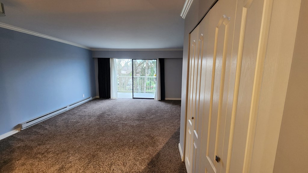 a bedroom with a closet and a window