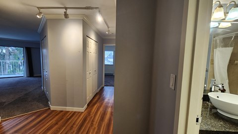 a renovated bathroom with a closet and a sink and a mirror