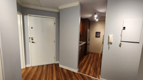 a room with wood floors and a white door