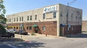 a building with a sign on the side of a street