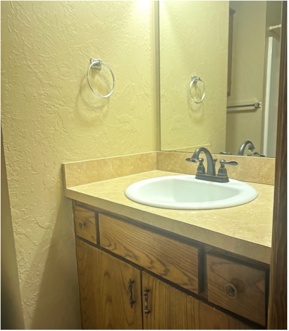 a bathroom with a sink and a mirror