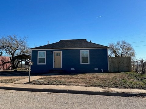 a blue house on the side of the street
