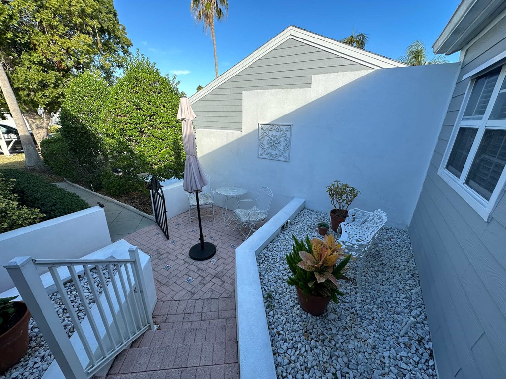 a view of the side of a house with a small courtyard
