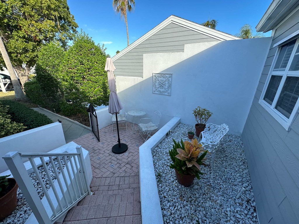 a view of the side of a house with a small courtyard
