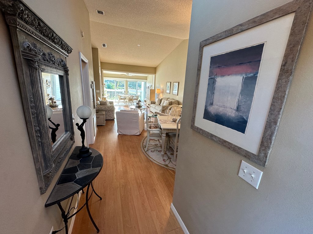a view of a living room and dining room from the hallway