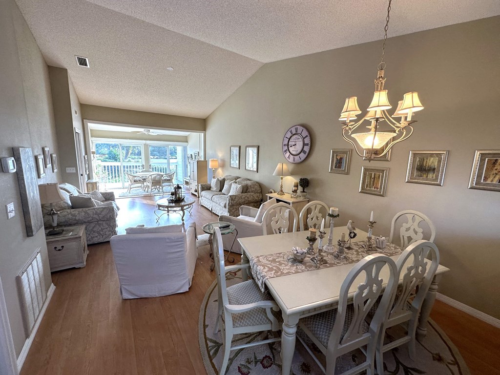 a view of the dining room and living room from the kitchen