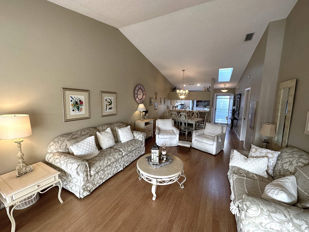 a living room with couches and chairs and a table