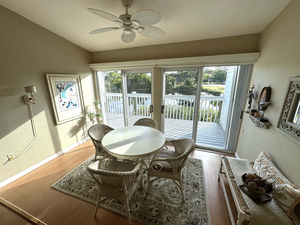 a dining room with a table and chairs and a balcony