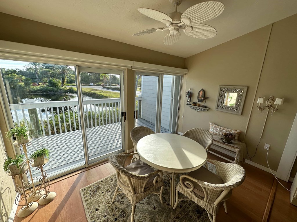 a dining room with a table and chairs and a balcony
