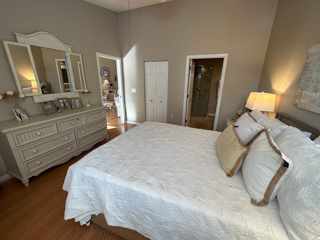 a bedroom with a large bed and a dresser