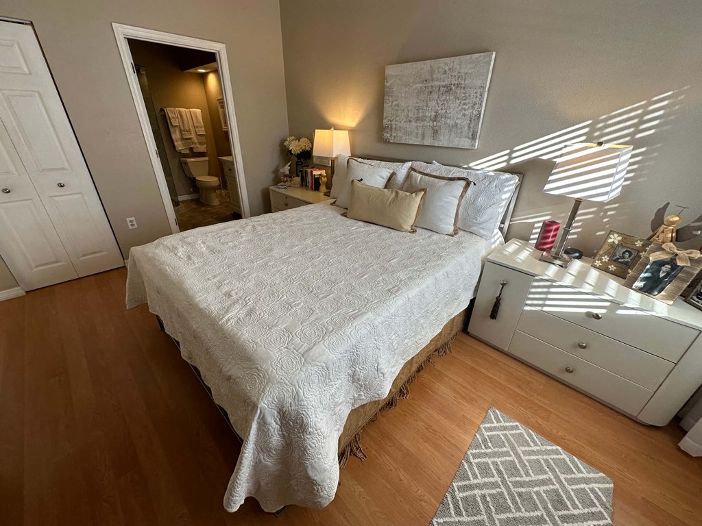 a bedroom with a bed and a dresser and a window