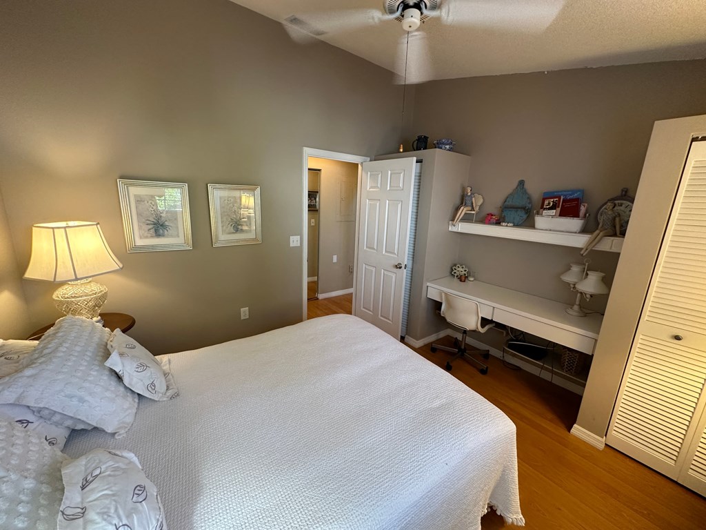 a bedroom with a large white bed and a closet