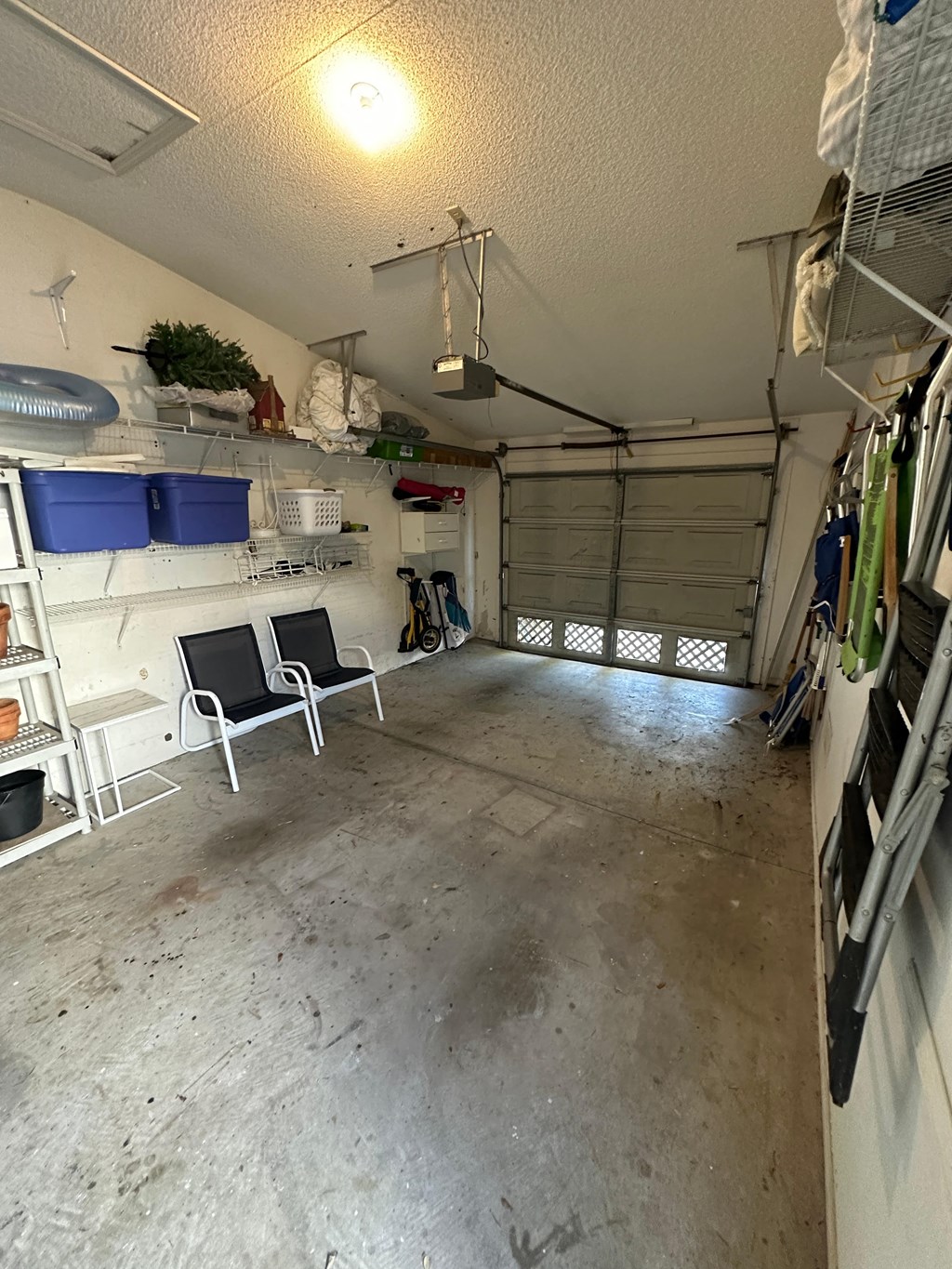 the inside of a garage with chairs and shelves