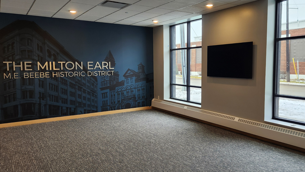 a room with a large wall mural of the milton earl me beer history