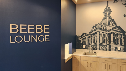 a bathroom with a sink and a wall with the words beer lounge