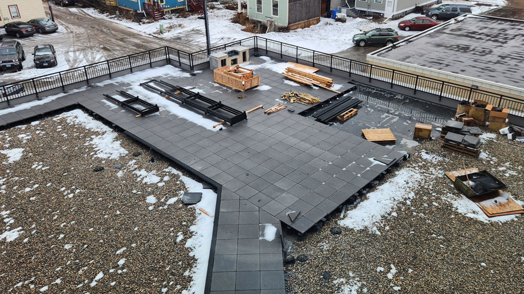 an aerial view of a parking lot with pieces of lumber on the ground