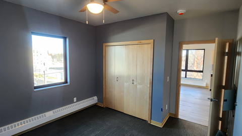 an empty room with a door and a window