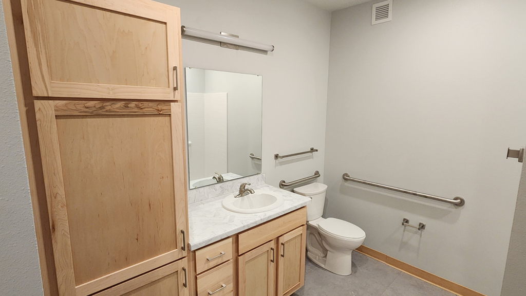 a bathroom with a sink toilet and a mirror