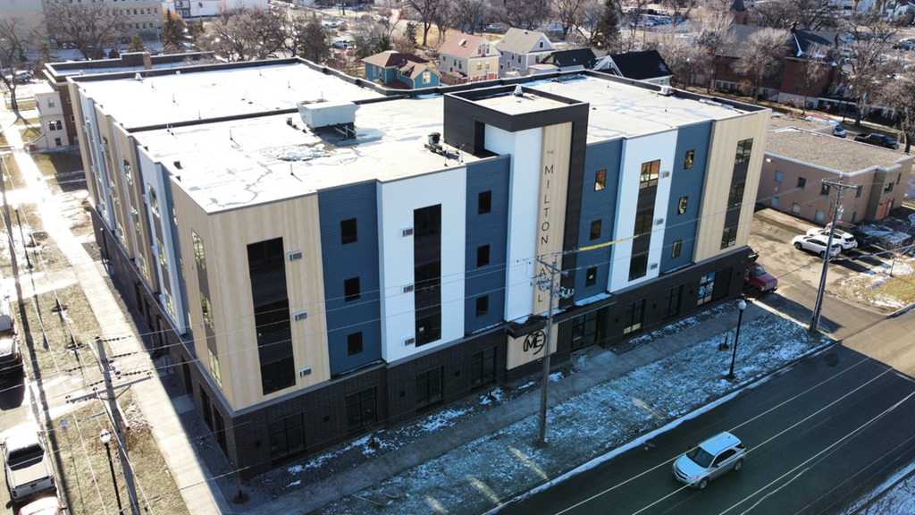 an aerial view of an apartment building in the snow