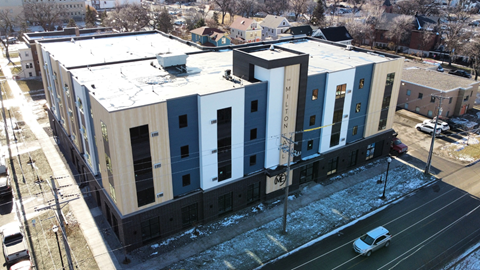 an aerial view of an apartment building in the snow