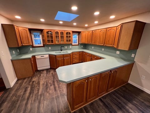 a kitchen with a counter top and wooden cabinets