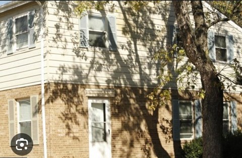 a house with a tree in front of it